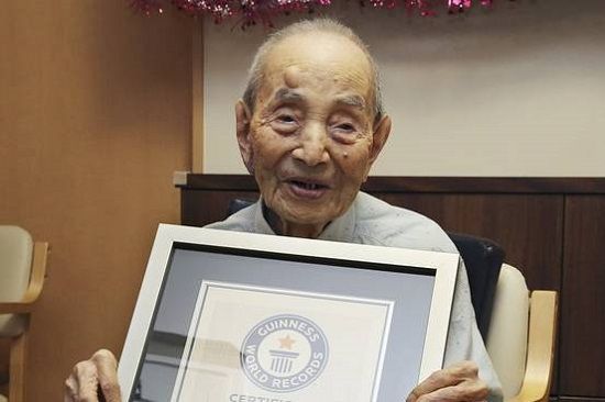 Yasutaro Koide receiving the Guinness World Records certificate after being recognized as the world’s oldest man